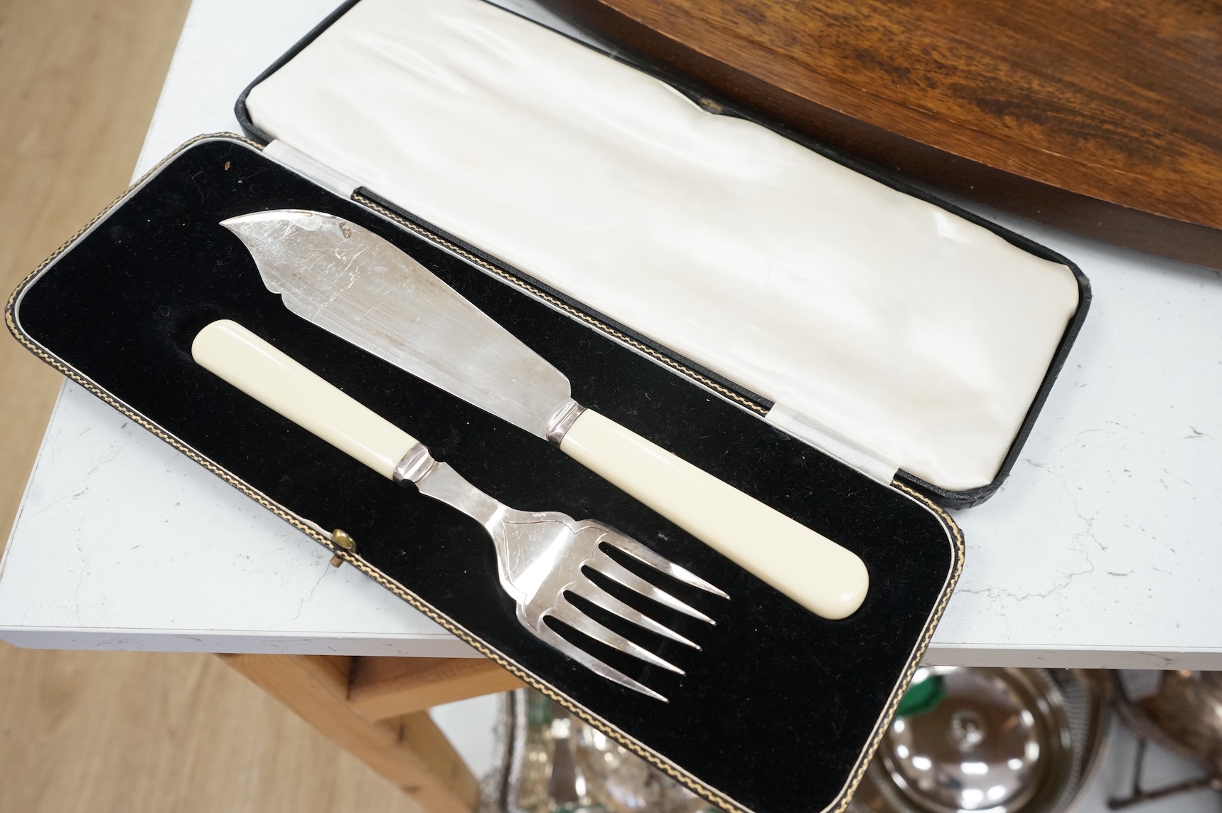 A wooden 'Fish' serving platter with plated mounts and a pair of servers, platter 87cm long
